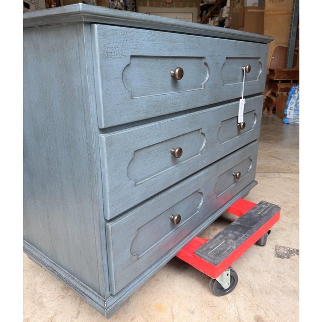 This transitional-style chest of drawers blends classic detailing with modern functionality. Finished in a soft denim blue...