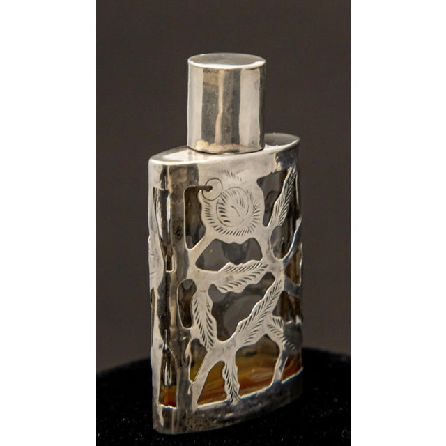 Offering this gorgeous Art Nouveau sterling silver over glass perfume bottle. It is smaller scale but the intricate detail...