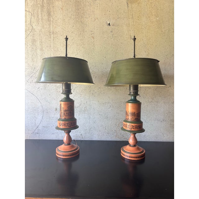 A striking pair of 1940s French painted toleware table lamps, retaining their wonderfully unusual original-style painted...