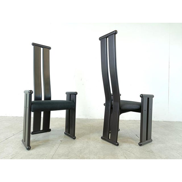 Striking vintage dining chairs with black ebonized wooden frames and a black fabric seat. The post modern design with the...