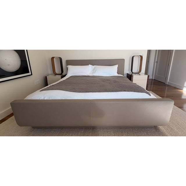 Custom-made Eastern King bed featuring full upholstery in smooth tan leather, including a fully wrapped leather base for a...