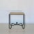Large iron and travertine 'Entretoise' side table or nightstand by Design Frères.