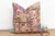 This 22-inch square pillow is a breathtaking example of Rajasthani textile art, handcrafted from rare antique Banjara...