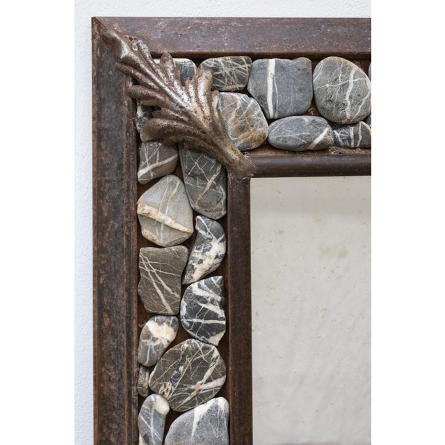 Magnificent large handcrafted mirror The frame is made of iron with decorative leaf elements. Set the stones collected on...