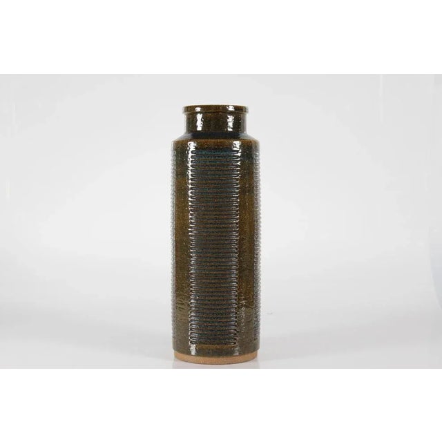 Huge palshus stoneware floorvase of chamotte clay model no. C 24. it's embossed with a grooved pattern in vertical broad...