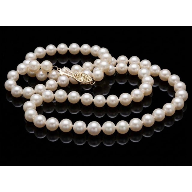 This elegant 18-inch strand features perfectly uniform 7mm Akoya pearls radiating with luminous pink undertones,...