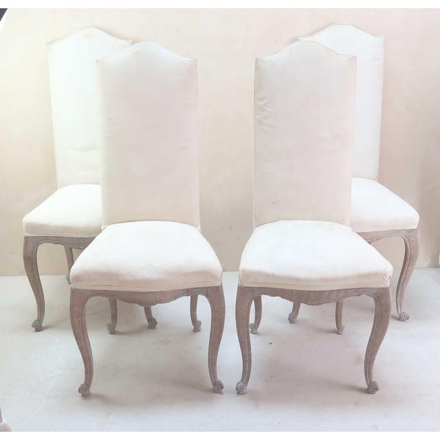 An elegant set of 4 dining chairs. There is a lovely sort of greyness to the wood Limed oak. The chairs have been stripped...