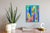 This artwork features a vibrant composition of geometric shapes and bold colors, creating a dynamic interplay between form...