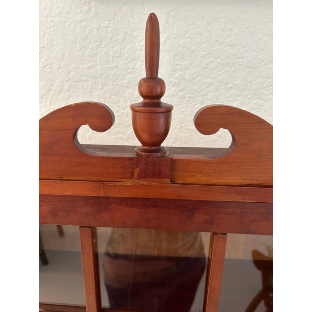 Lovely American Federal style Mahogany wood hanging curio cabinet featuring a paned glass, hinged door that opens to...