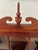 Lovely American Federal style Mahogany wood hanging curio cabinet featuring a paned glass, hinged door that opens to...