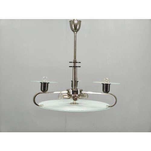 Elegant Art Deco chandelier produced in Czechoslovakia during the 1930s, crafted from chrome plated metal and layered...