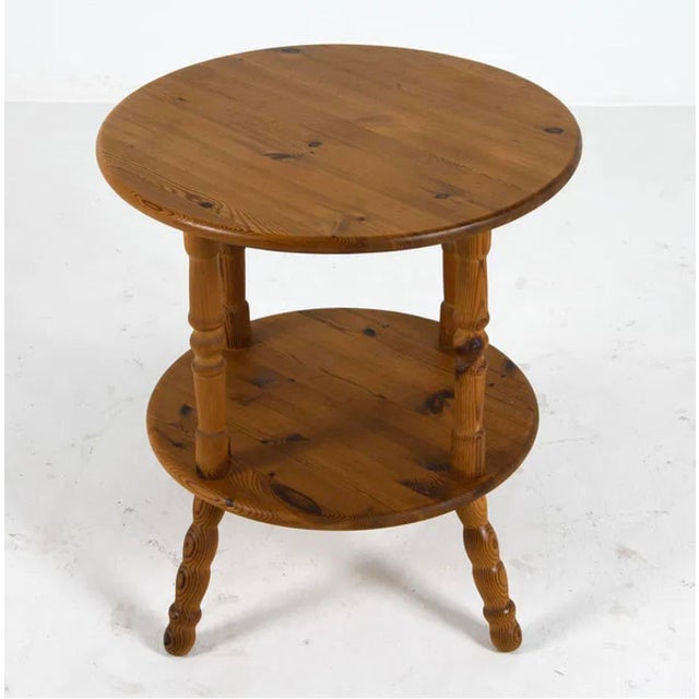 A charming and character-rich English cricket table crafted in solid pine, dating to the mid-20th century. Traditionally...