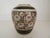 This vase is done in a floral motif and is very colorful. Hand painted and with a gold on black band top and bottom of the...
