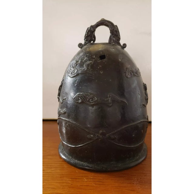 This is a Mid to Late 19th Century Chinese Bronze Bell Shaped Chang‘e Motif Incense Censer. It measures 8" high and 5 1/2“...