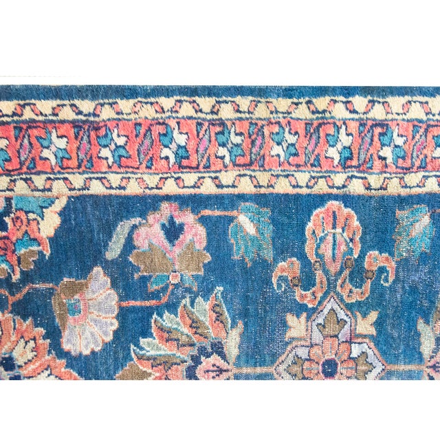 A beautiful hand-woven antique Persian Lilihan runner rug dating to the 1920s. This long runner features a vibrant deep...