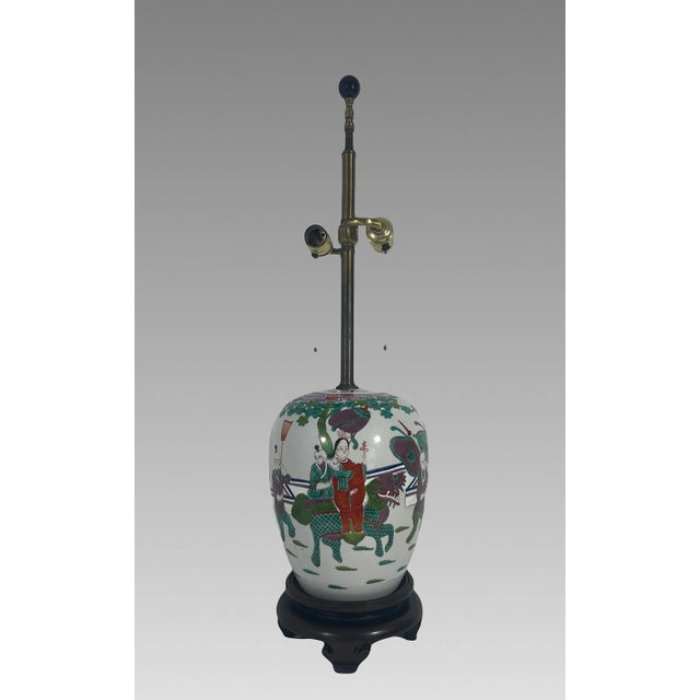 A traditional Guangxu Period ovoid from Chinese porcelain ginger jar table lamp on a carved dark brown wooden base. This...