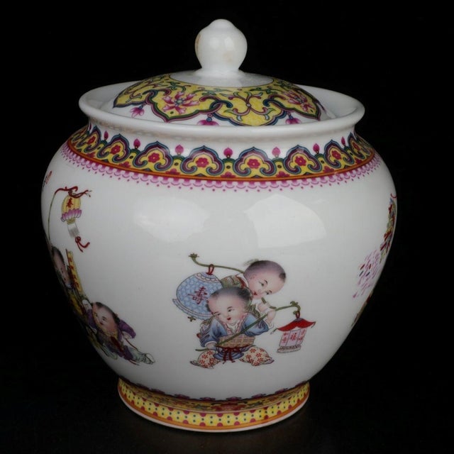Beautiful Chinese famille rose porcelain lidded jar decorated with a lively scene of playful children celebrating spring....
