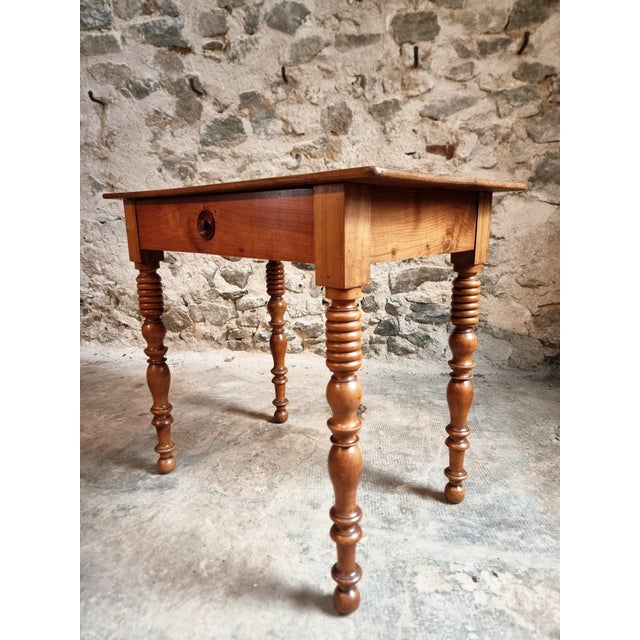 This antique French small writing table, dating from around 1900, is crafted from solid walnut and reflects the...
