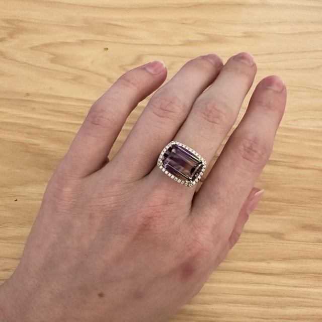 An ametrine rests in a blend of golden citrine and purple amethyst at the heart of this solid 14K yellow gold ring,...