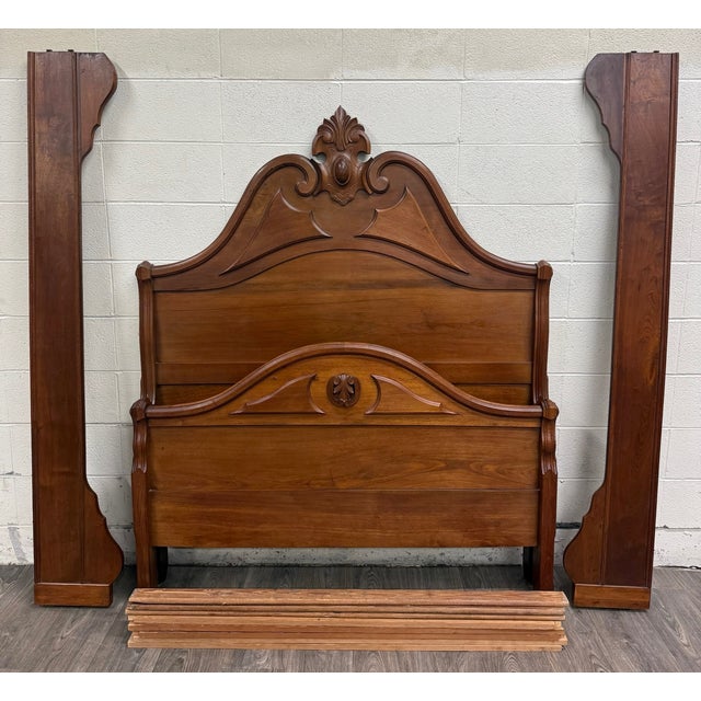 This is a beautifully carved late-Victorian full-size bed crafted in richly grained walnut. The tall arched headboard...