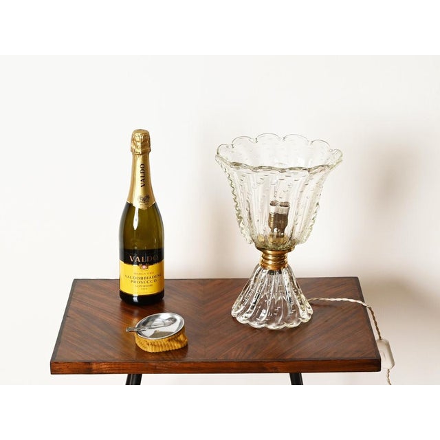 Stunning and rare large floral table lamp in murano mouth-blown bullicante glass and brass. This charming piece was...