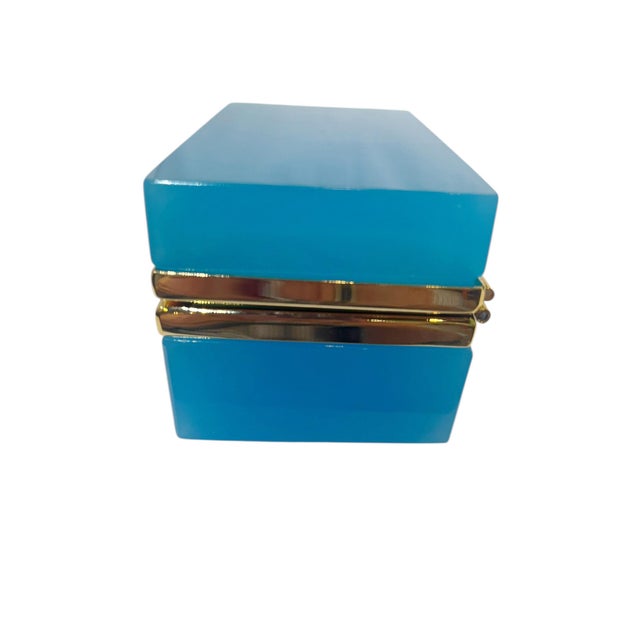 An elegant French rectangular opaline glass box dating to circa 1940. The soft blue opaline glass has a smooth luminous...