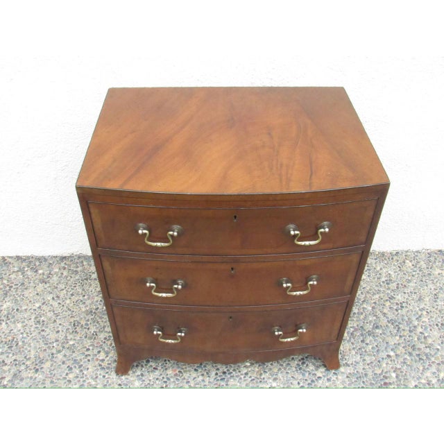 Small scale English mahogany bow front chest of drawers, c.1920’s A handsome dresser in flame mahogany showing a flowing...