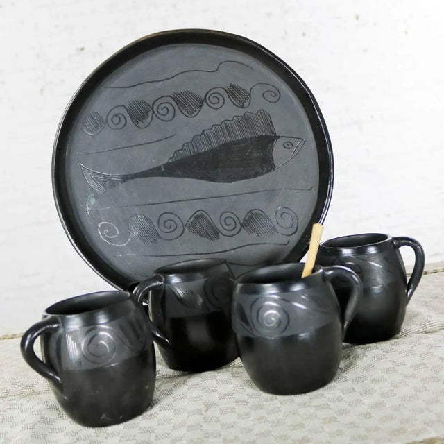 Handsome black clay or barro negro pottery hot chocolate set most likely from Oaxaca, Mexico consisting of 4 mugs, tray...