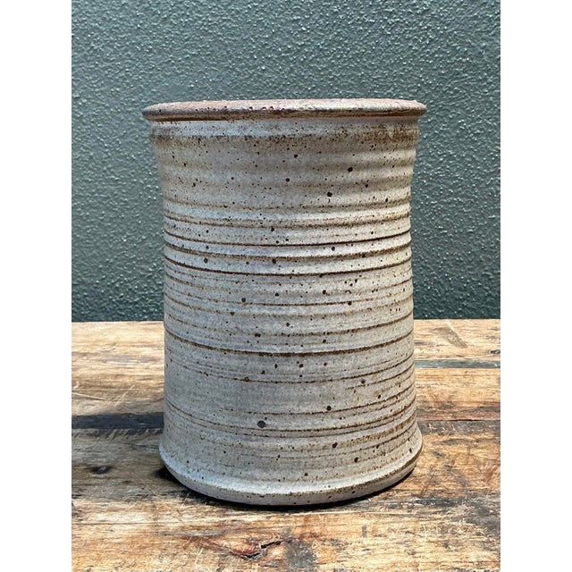 This original studio pottery vase is a masterclass in tactile minimalism and organic texture. Hand-thrown with meticulous...