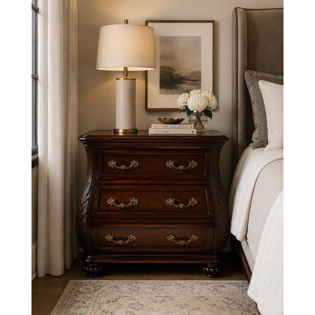 MOBILE-READY DESCRIPTION A richly detailed Bombay-style three-drawer chest featuring dramatic bombe curves, carved leaf...