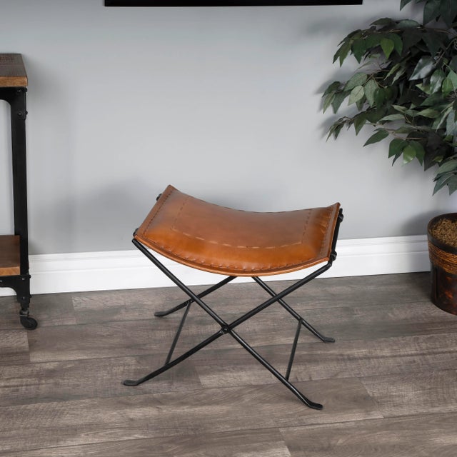 Leather meets iron for a simple seat, ideal for any spot in your home. Great alone or in multiples, its carefully stitched...