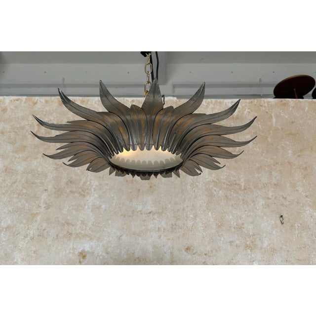 This handsome Spanish 1950s metal ceiling fixture features alternating and overlapping large and small leaves in a...