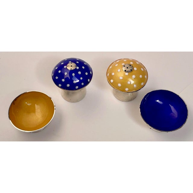 This is a charming set of 1960s sterling and enamel shakers and salt cellars. One mushroom has a cobalt blue polkadot...