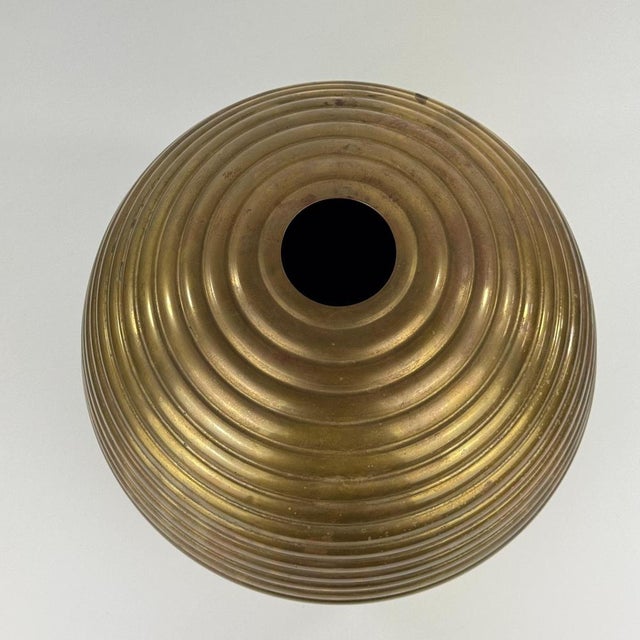 A striking and sculptural brass vase produced by laras in padua, representative of the refined italian metalwork of the...