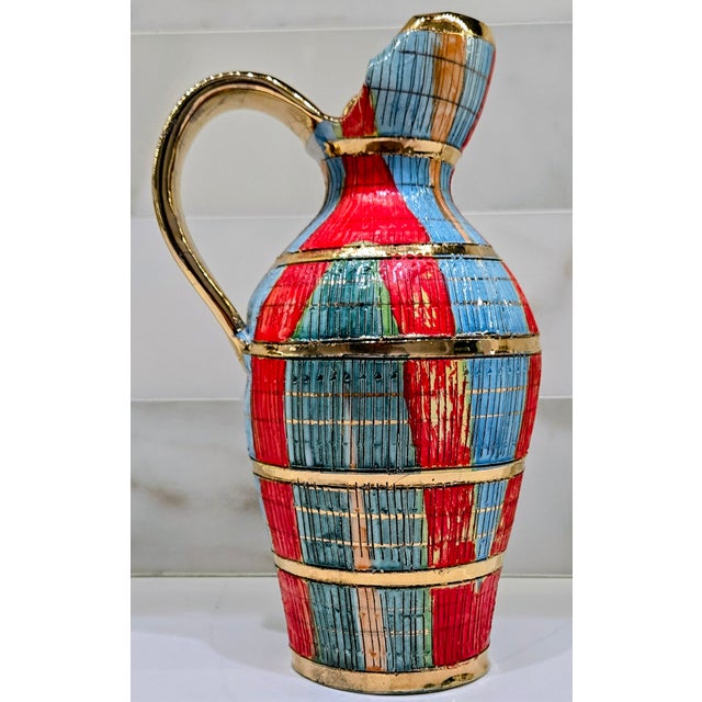 Striking mid‑century Italian pottery pitcher in the Seta‑style associated with Aldo Londi for Bitossi, featuring richly...