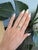 A natural tsavorite garnet from Tanzania brings electric green brilliance to this round ring, framed by sparkling diamonds...