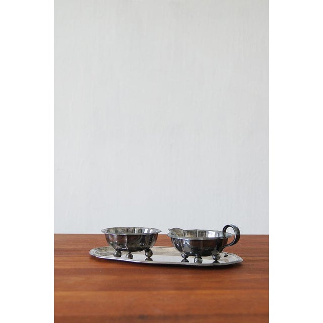 An exquisite set consisting of a sugar bowl, a creamer and a tray. Creamer and sugar bowl is an essential duet of every...