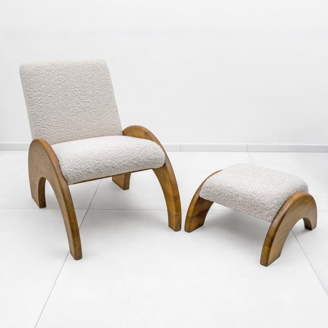 Elegant lounge set composed of an armchair and matching ottoman, distinguished by its sculptural and contemporary design,...