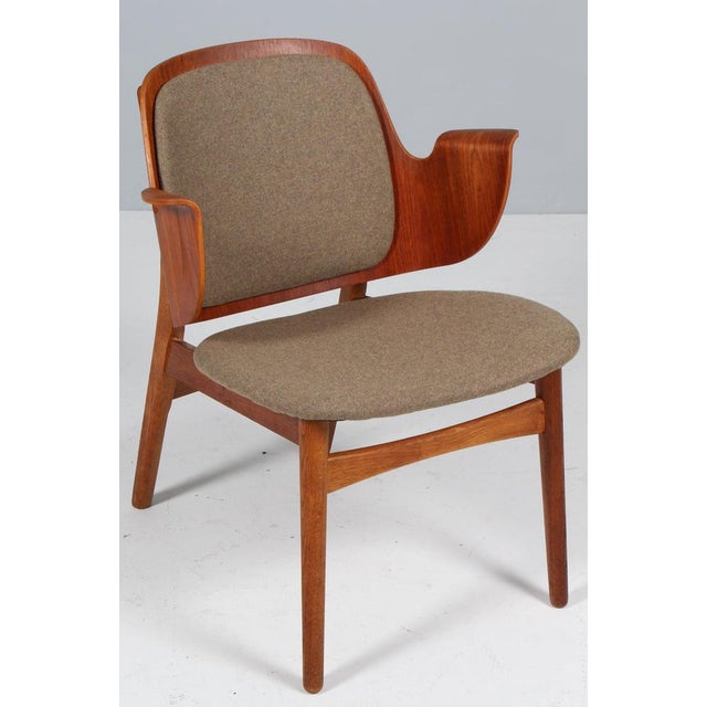 Hans Olsen lounge chair with frame of oak. Back of teak. Seat new upholstered with wool fabric. Model 107, made by Bramin....