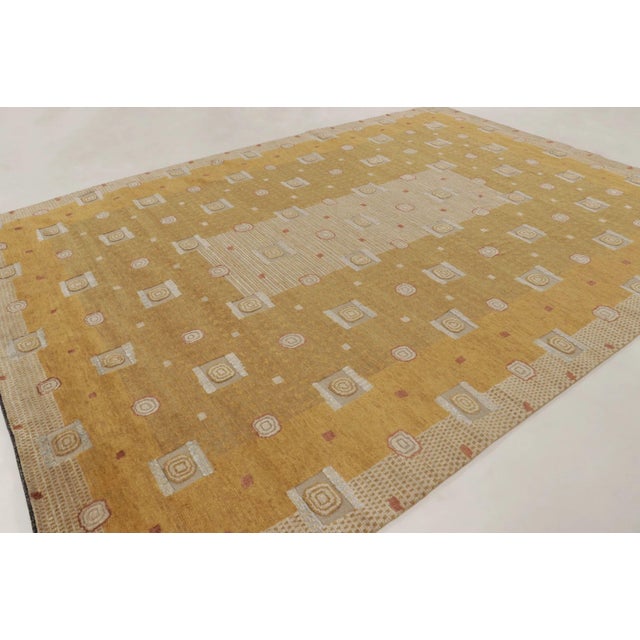 This oversized 10x14 Scandinavian rug presents a sophisticated geometric composition in wool and sari silk. A warm golden...