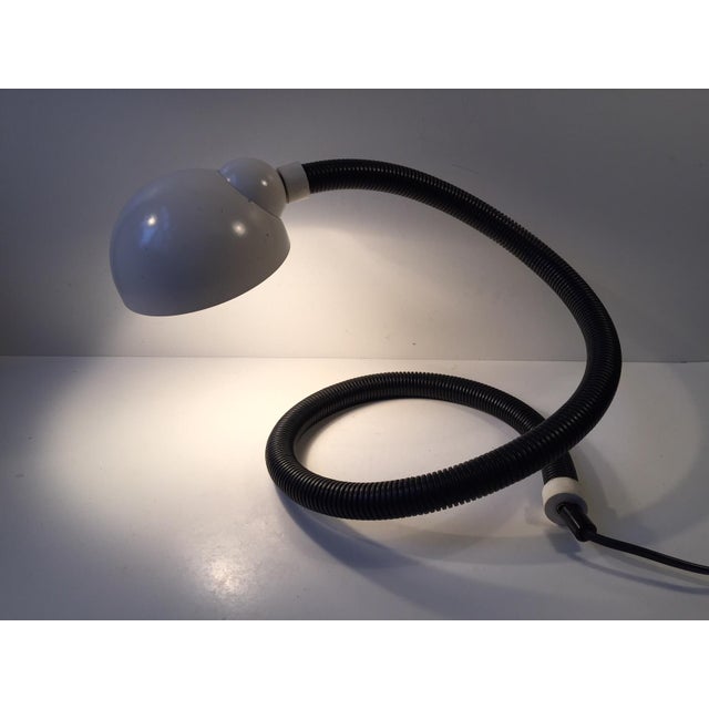 This table lamp is often referred to as snake or cobra in reference to its shape. The piece was manufactured by the German...