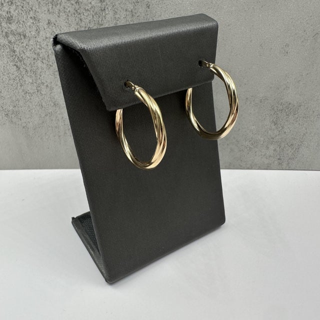 These elegant twisted hoop earrings in 14kt yellow gold feature a classic design with a polished, rope-like twist that...