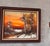 Vintage oil on canvas depicting a serene winter landscape at sunset, rendered in rich orange, rust and earthy tones with...