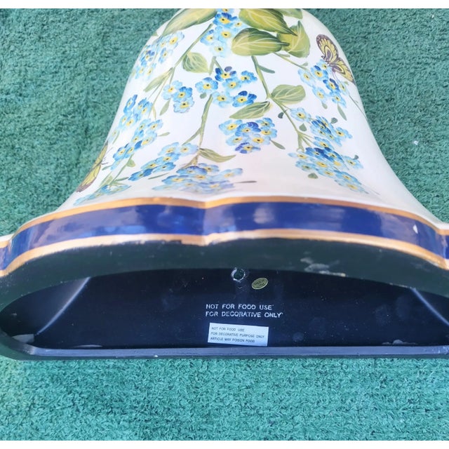 A beautiful floral ceramic wall pocket in the style of Chelsea house. The pocket features a cream background with navy...