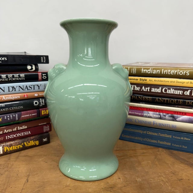 "About This Piece About This Piece This vase carries a presence of quiet strength and grace. Its smooth celadon glaze...
