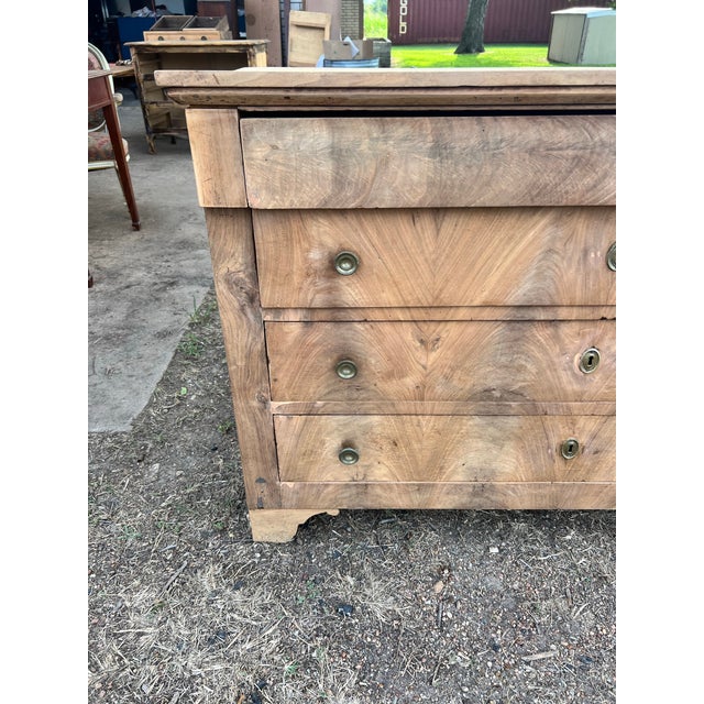 A beautiful French Louis Philippe commode from the 19th century, crafted in solid walnut with stunning book-matched walnut...