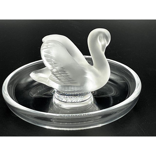 The Lalique Swan Ring Holder is a unique work of art that combines the elegance and beauty of Lalique's artistic mastery....