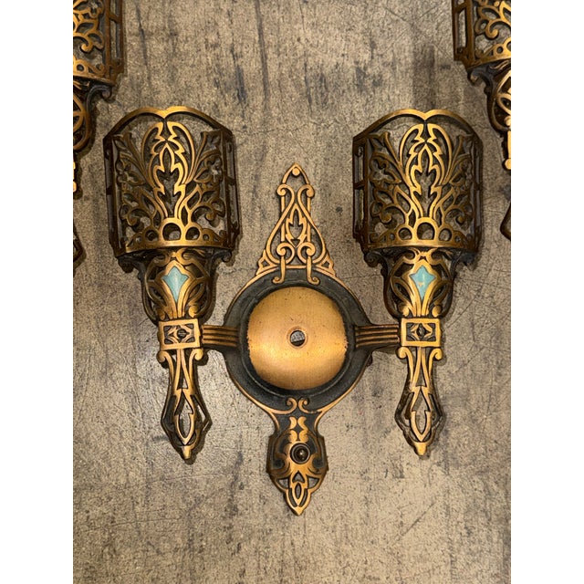 A striking and increasingly scarce set of three original Art Deco wall sconces, beautifully executed in polychrome with...
