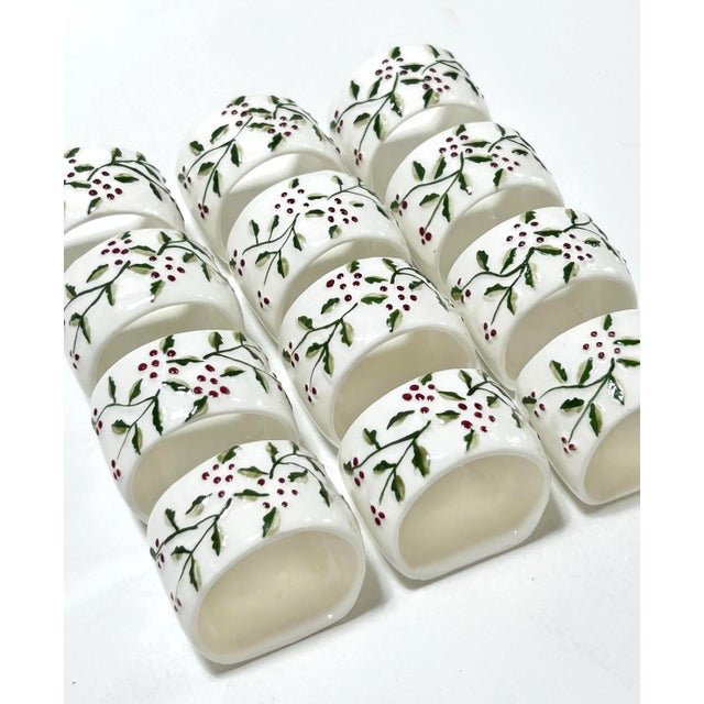 Set of 12 vintage fine bone china Christmas napkin rings decorated with delicate holly branches and red berries in raised...