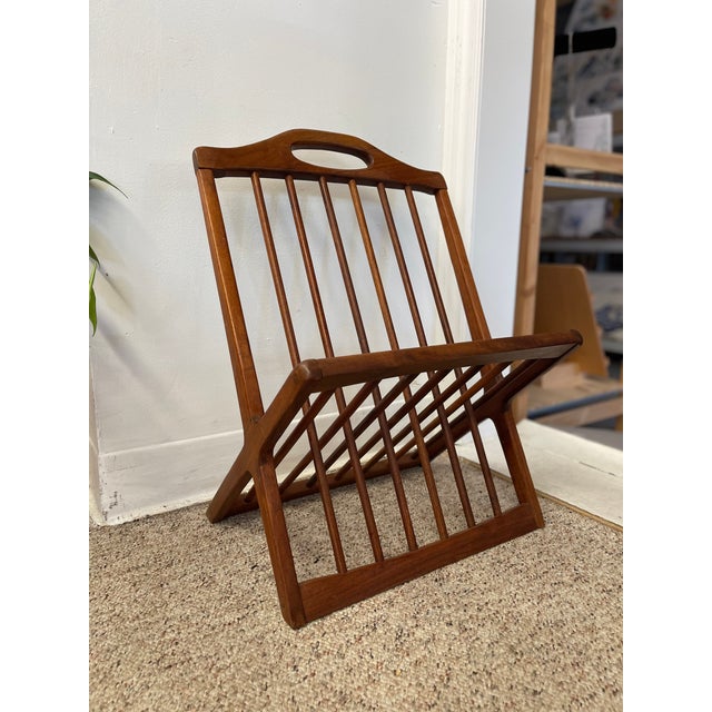 This vintage mid-century modern magazine rack, attributed to Arthur Umanoff, exemplifies the clean lines and functional...